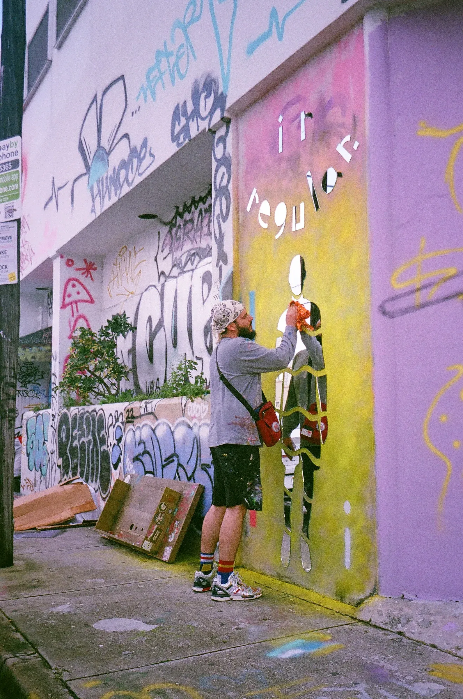 A street artist painting a colorful doorway.