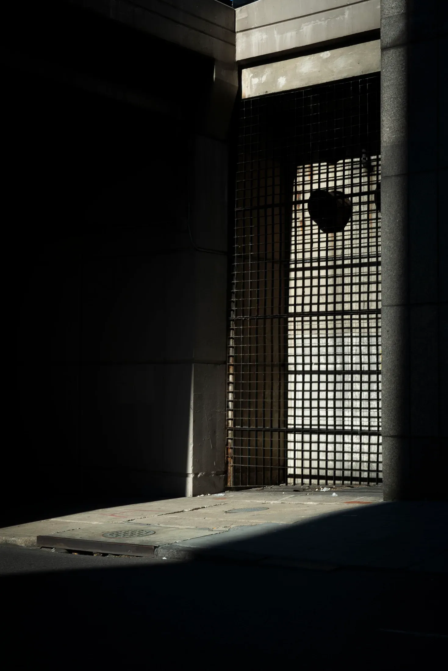 A shaft of sunlight cutting through a dark doorway.