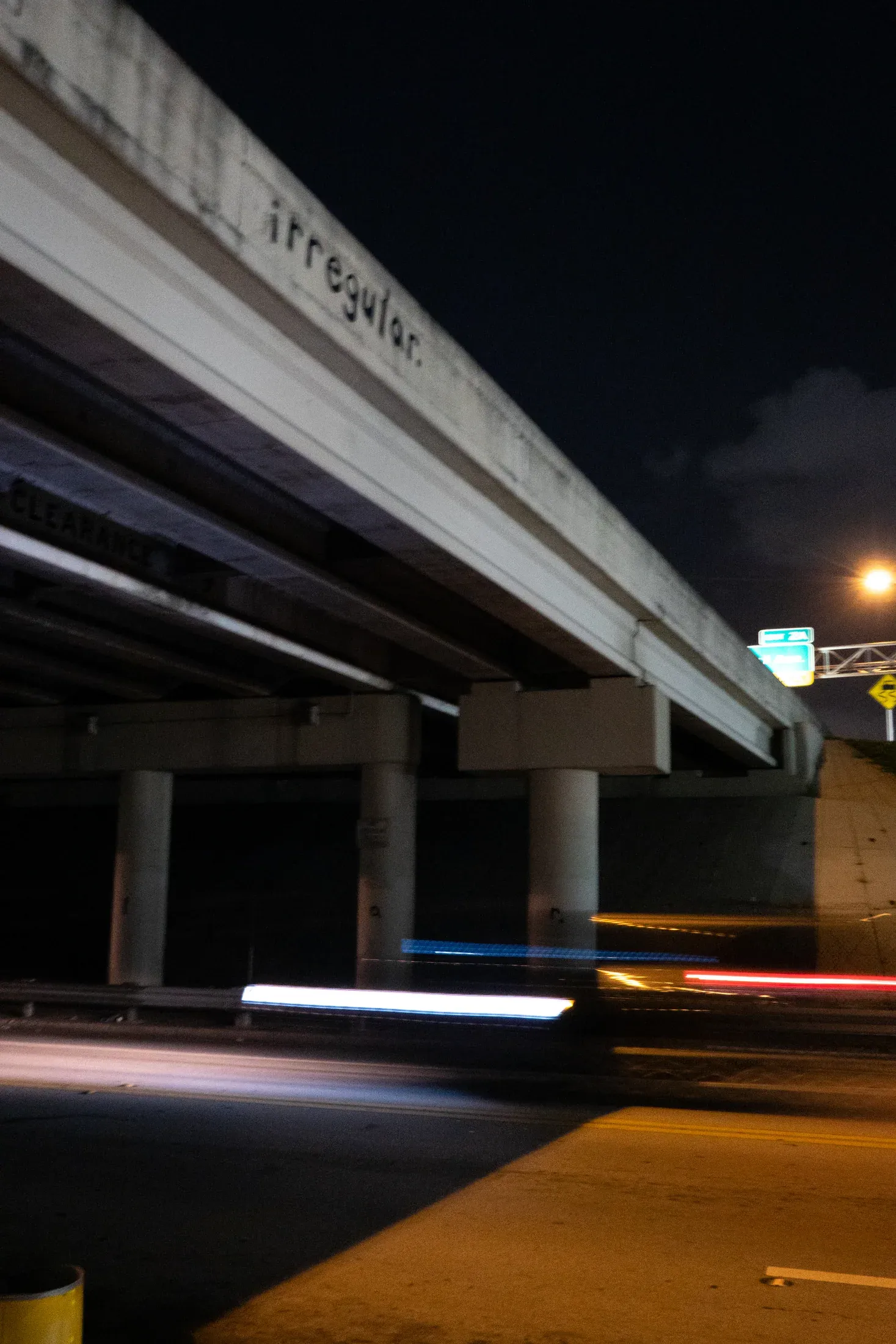 Night traffic and concrete structure framing the Miami street environment.