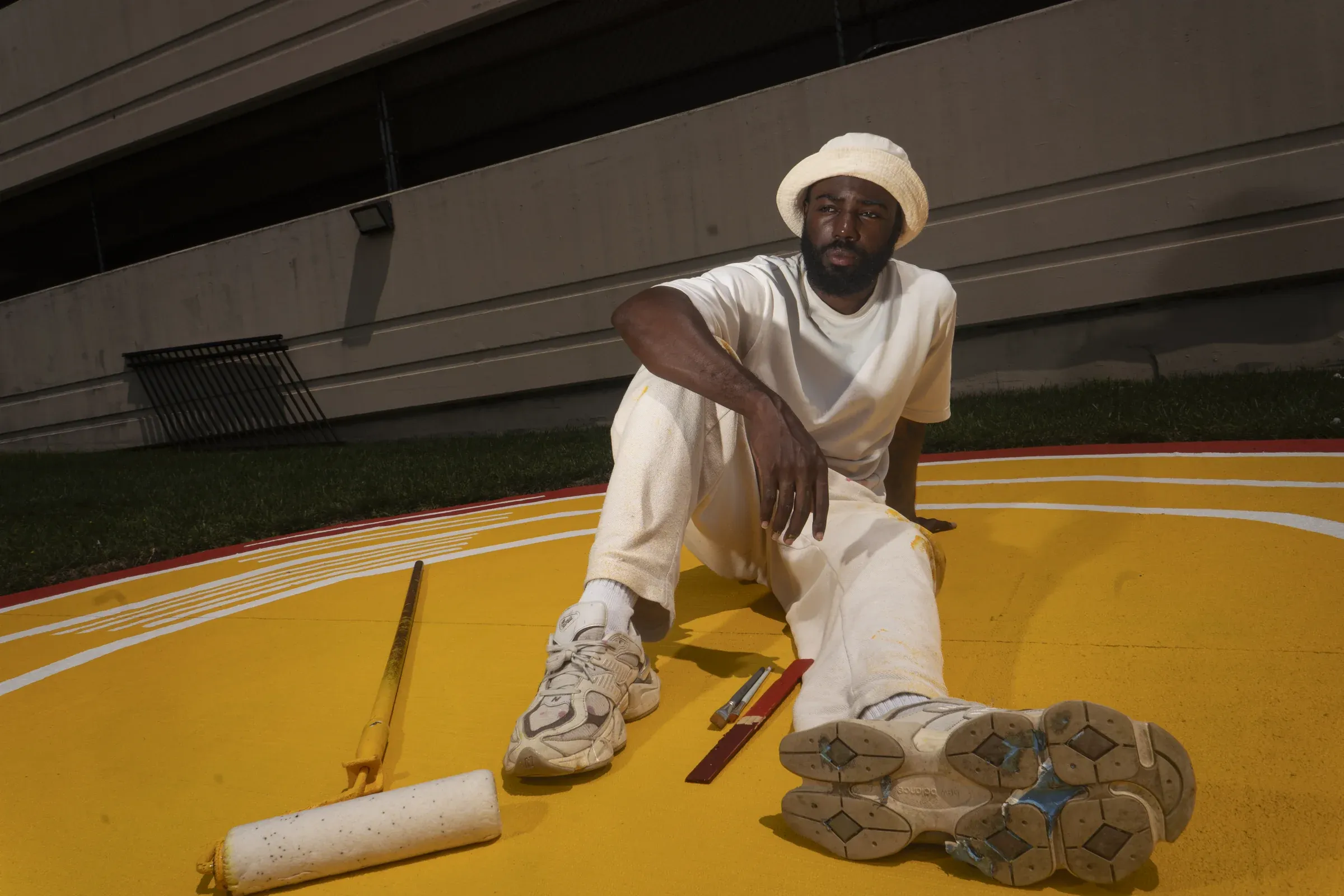 Andre Chaney seated on the completed public basketball court.
