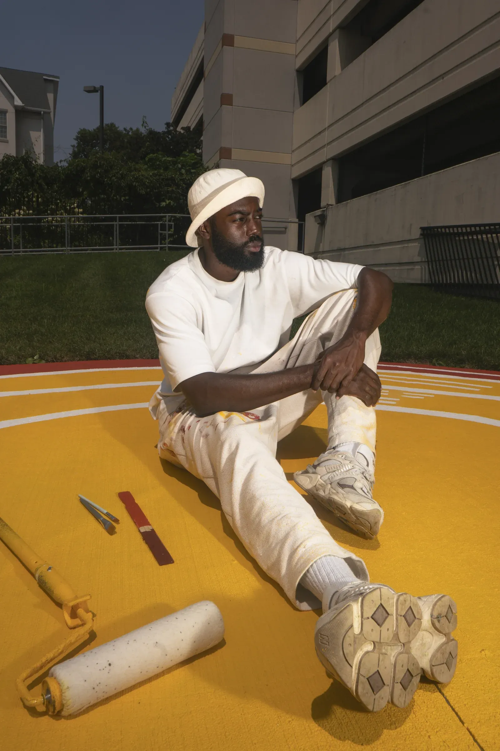Andre Chaney working within a colorful public-art installation.