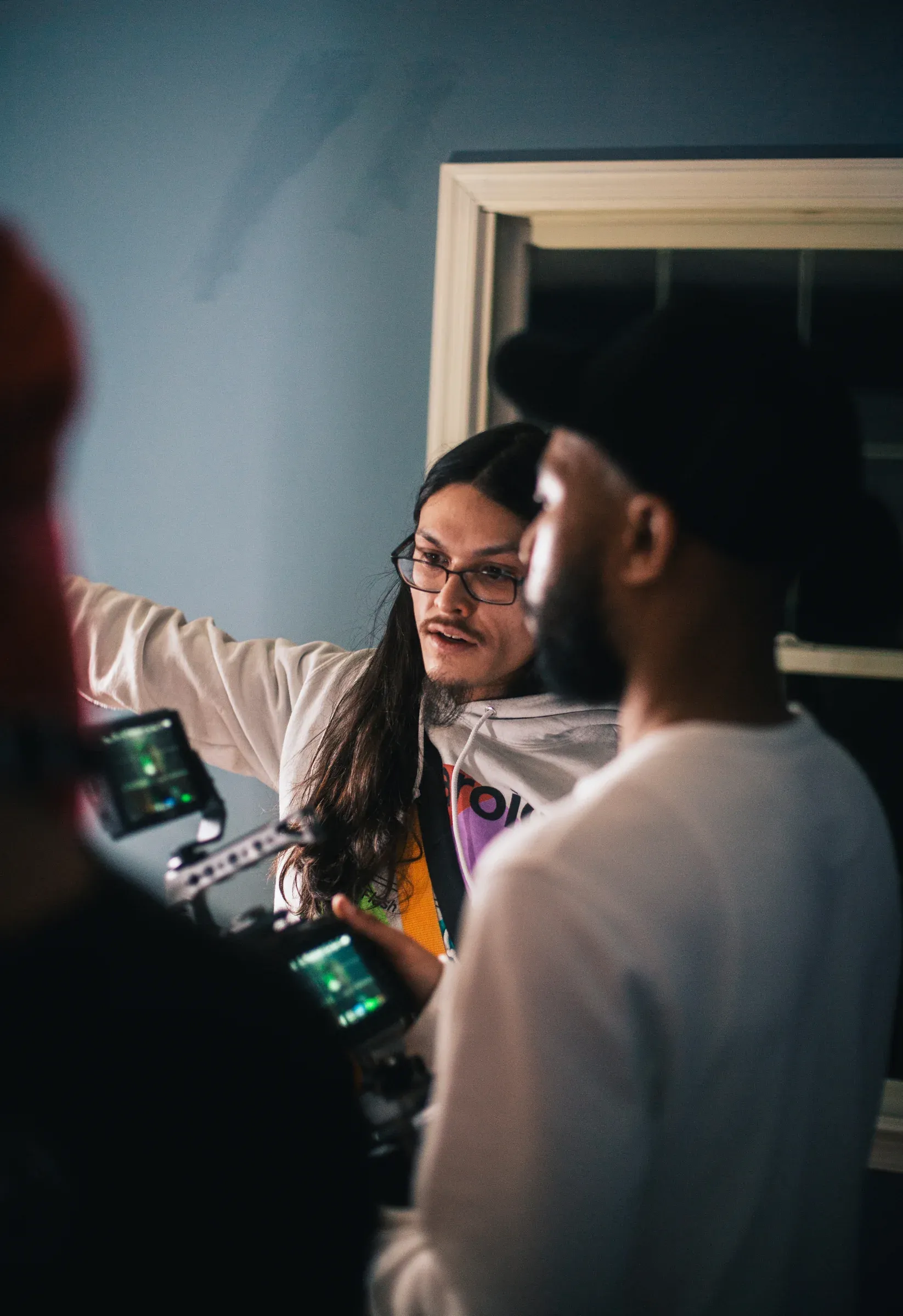 Joshua Hoang directing a performance beside the camera monitor.