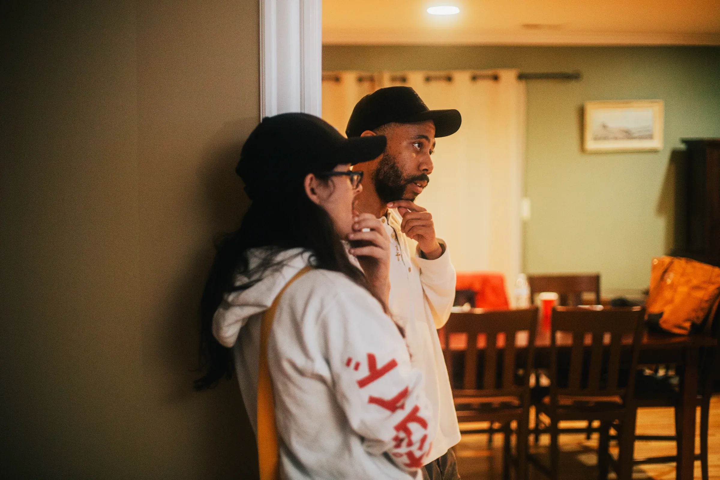 Members of the crew talking together inside the house-party location.
