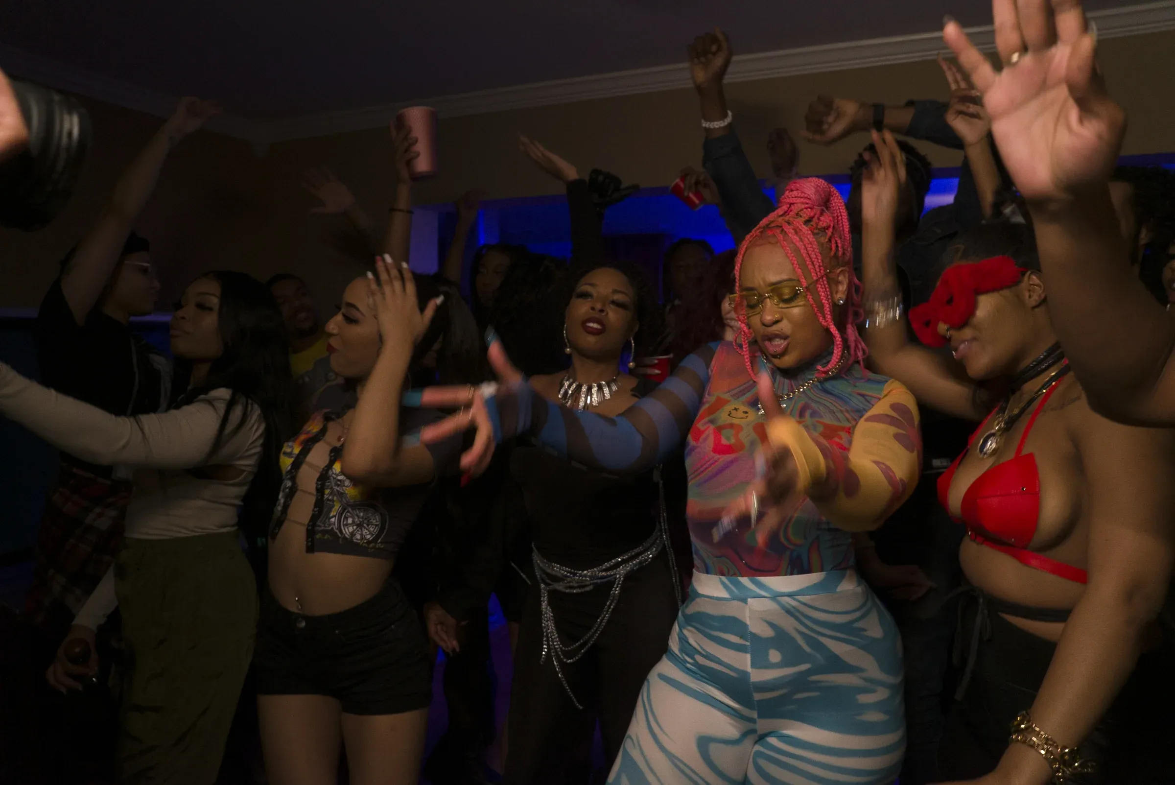 Aquaa Mermaid performing while a house party moves around her.