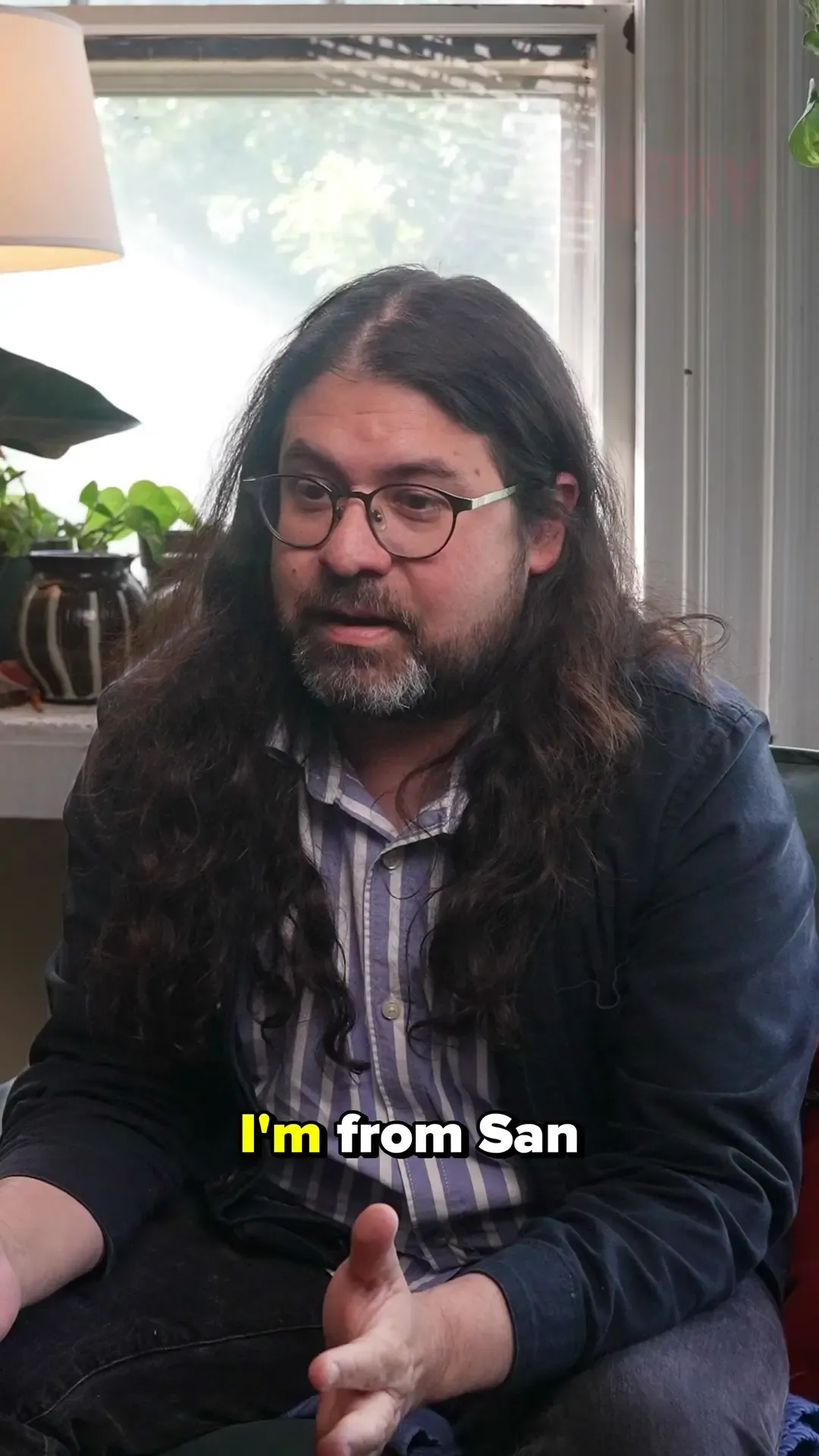 Ricky Yanas seated for an America // América artist interview.